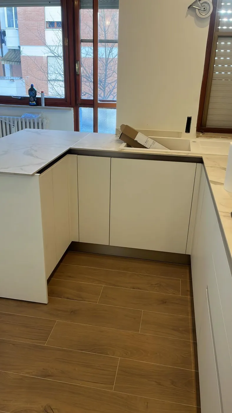 Dettaglio delle basi cucina con zoccolo e piano in marmo appena montati